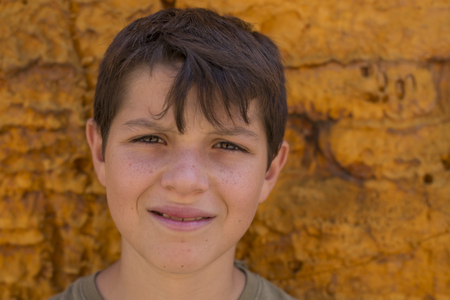 Portrait of a handsome young teen, over a yellow background ( lifestyle )