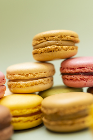 Vintage pastel colored French macaroons or macarons on green backgroundの写真素材