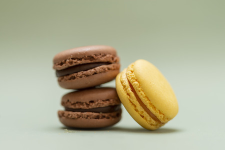 Vintage pastel colored French macaroons or macarons on green backgroundの写真素材