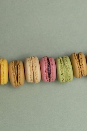 Colored tasty  macaroons over a green background.の写真素材