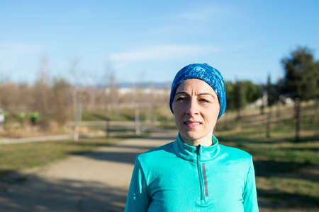 Portrait of woman wearing sports clothes in the parkの写真素材