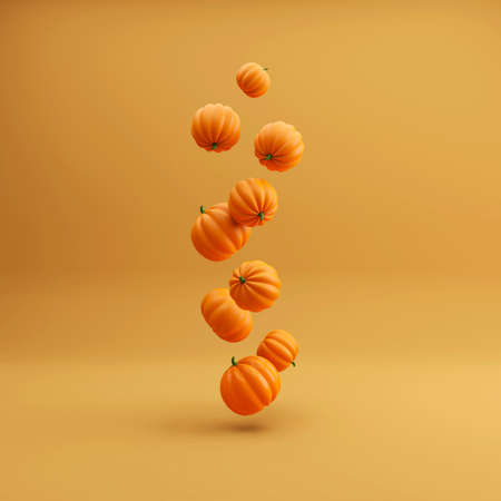 Flying Orange halloween pumpkins on orange background, holiday decoration. 3d illustrationの写真素材
