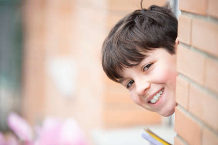 A Cheerful teen boy smiling while looking to camera