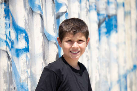 Portrait of handsome male child in the city outdoors. Natural light.の写真素材