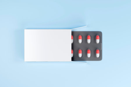 Blank packaging and medical capsules close up on blue background. 3d illustration