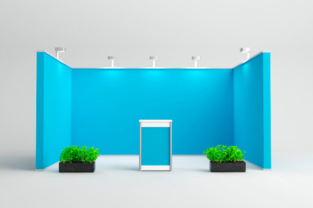 A blue exhibition booth setup with a central podium and green plants on both sides, illuminated by spotlights. Ideal for eco-friendly brand displays.の写真素材