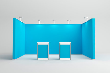 A modern blue exhibition booth setup with two display counters in the center, highlighted by overhead spotlights. Ideal for brand promotion and product showcases.の写真素材