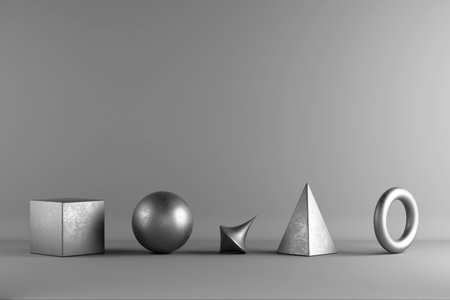 Five metallic 3D shapes â cube, sphere, spike, pyramid, and torus â are arranged in a row on a gray background in a minimalist studio setup.の写真素材
