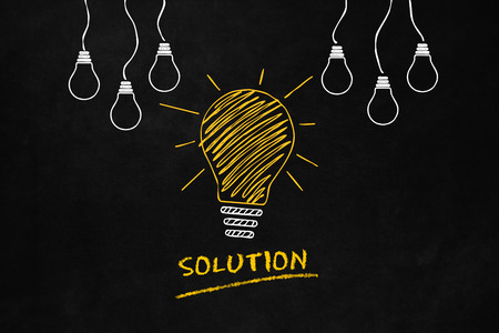 A light bulb drawn on a blackboard indicates a solution, A conceptual design of a solution's idea, A Big Yellow Light Bulb with 6 smaller white light bulbs and Text "Solution"の写真素材