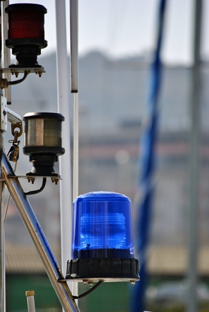 blue, white and red flashing lights on a fishing boatの写真素材