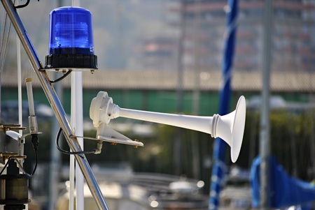 blue flashing light and a white horn on a boat in the harborの写真素材