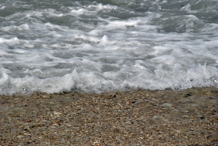 windy day at sea with big waves against rocksの写真素材