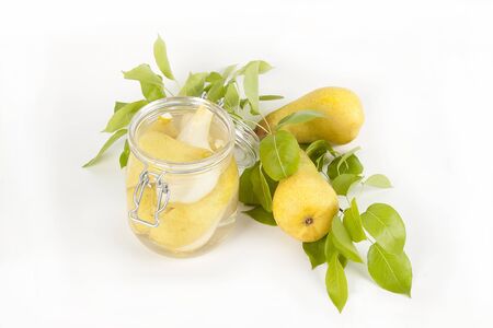 Pears on branch and in glass jar isolated on white background.の写真素材