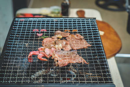 Fresh beef sliced for steak or grilled barbecue with beef tong on cutting board. meat tongs on a cutting board with Sliced fresh meat for steaks or barbecue grilled party at home.の写真素材