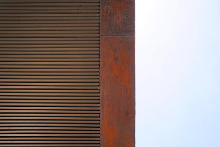 close up of old rusty metal wall with blue sky in the background.の写真素材