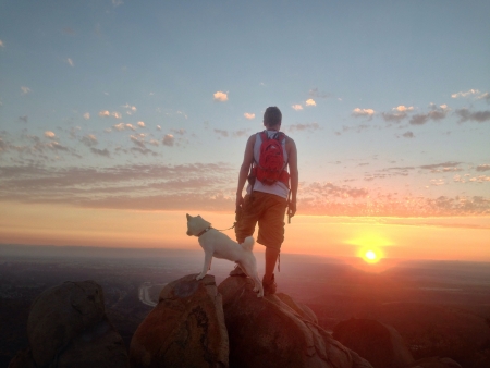 A man and his dog admiring the viewの素材