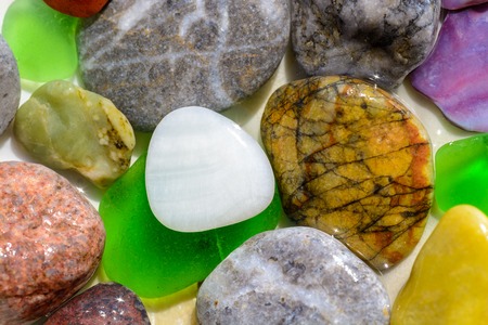 Set of stones, polished glasses and shell parts on sea shore