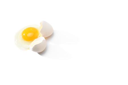 Broken egg with eggshell on white background