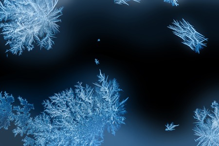 Frozen windows in winter time with frost decorationsの写真素材