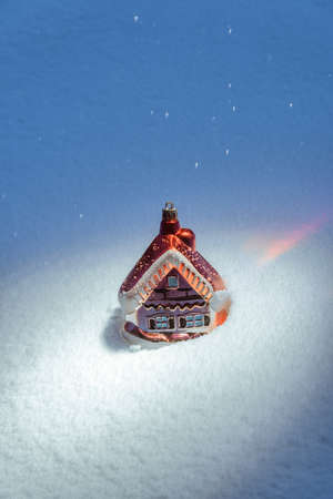 Small Christmas decoration standing in snow as part of fairytaleの写真素材