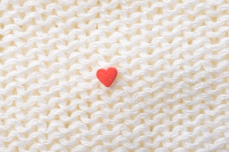 Heart shaped small candies on sugar as background