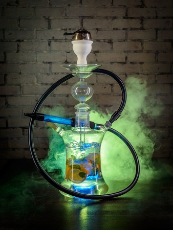 Colorful glass smoking hookah with fruits inside