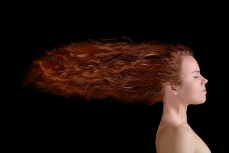 Side view of young woman with long artistic hair