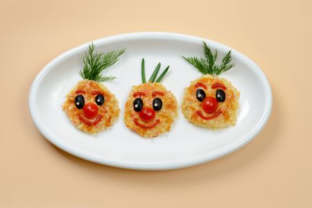 Vegetable cutlets decorated as funny smily facesの写真素材