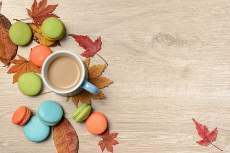 Sweet muufins on wooden table with cup of hot cocoa