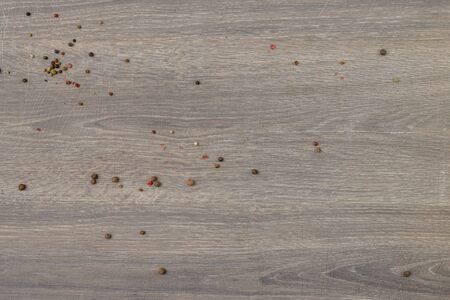 Allspice scattered on wooden tableuseful as food backgroundの写真素材