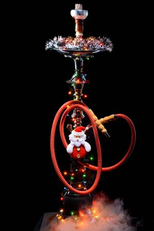 Smoking hookah with New Years decorations on dark background