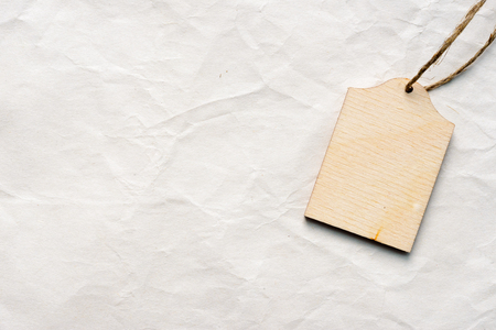 Handmade wooden label on textile background as greeting cardの写真素材