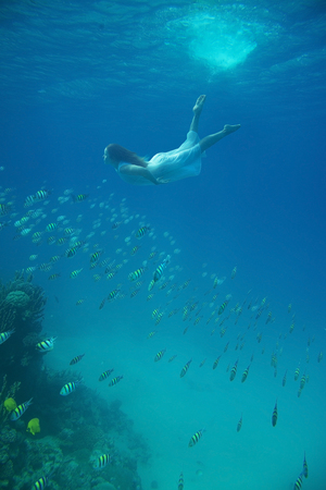Girl in white underwaterの写真素材