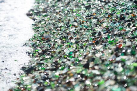 Beach fully covered with multicolored glass pebble. Wonder of nature.の写真素材