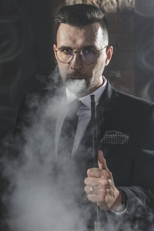 Fashionable man smokes