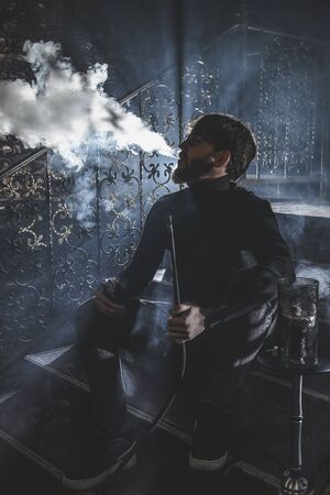 Man smokes hookah