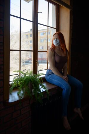 Redhead woman at quarantineの写真素材