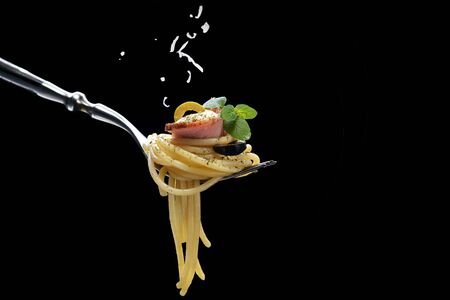 Spaghetti with bacon on forkの写真素材