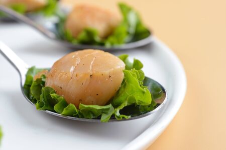 Scallop snack on spoonの写真素材
