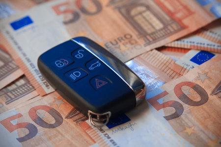 Car remote over banknotes. Close up view.の写真素材