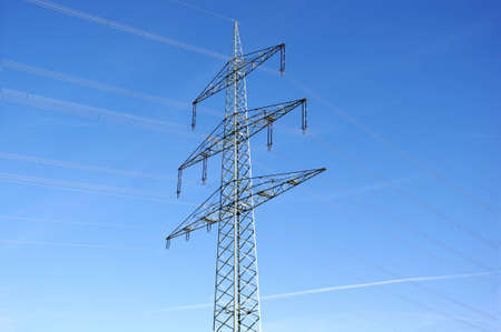 Electricity pylon against blue sky.の写真素材
