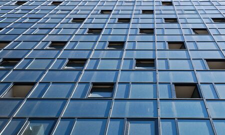  Wall of modern office building and sky reflectionの写真素材