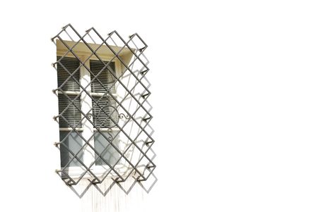 small window with grate in white wallの写真素材