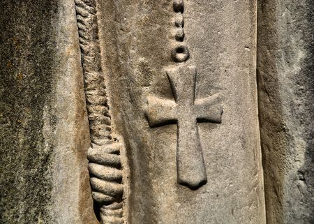 Cross on textured wall. Fragment of an old monument in the cemeteryの写真素材