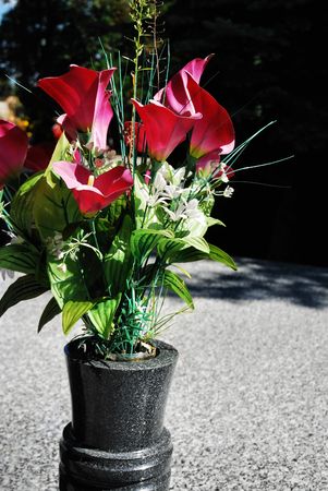 Plastic flower and marble styled grave on cemetery
の写真素材