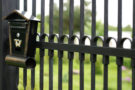 old mailbox fixed to the metal fence の写真素材
