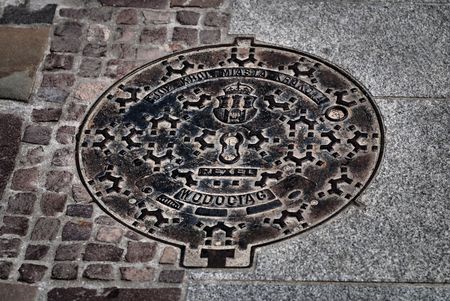 emblem of the city of Krakow on an iron plateの写真素材