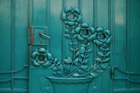 old wooden door with aged flower texture の写真素材