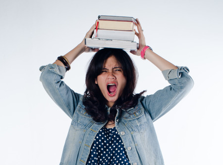 Young college girl so depressed with so many book