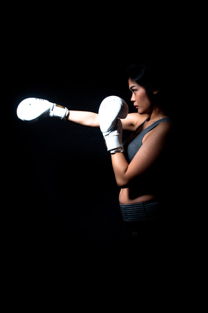Asian Female Boxer on Black Background